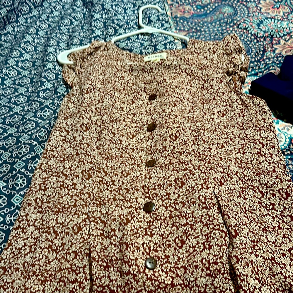 It’s a brown combination dressing with button on